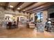 Open-concept living room with stone accents, wood beams, fireplace, and access to a dining area at 40947 N 107Th Pl, Scottsdale, AZ 85262