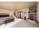 Main bedroom featuring a stone fireplace, and access to an outdoor patio at 40947 N 107Th Pl, Scottsdale, AZ 85262