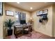 Cozy home office with a rustic desk, wood floors, and natural lighting at 40947 N 107Th Pl, Scottsdale, AZ 85262