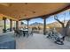 Covered patio includes a dining area and lounge space with mountain views in the background at 40947 N 107Th Pl, Scottsdale, AZ 85262