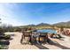 Relaxing lounge chairs offer views of the pool, golf course, desert landscape, and mountains at 40947 N 107Th Pl, Scottsdale, AZ 85262