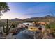 Outdoor pool and spa area with desert landscaping, lounge chairs, and a mountain view at 40947 N 107Th Pl, Scottsdale, AZ 85262