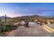 Backyard view of sparkling pool, fire pit, desert landscape, and mountain views at 40947 N 107Th Pl, Scottsdale, AZ 85262