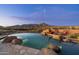 Beautiful pool and jacuzzi featuring rock accents, a desert vista and cozy patio seating at 40947 N 107Th Pl, Scottsdale, AZ 85262