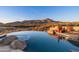 Infinity pool showcases mountain views and desert plants in a luxurious outdoor space at 40947 N 107Th Pl, Scottsdale, AZ 85262