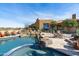 Backyard pool and patio area with stone features and a lovely view of the home at 40947 N 107Th Pl, Scottsdale, AZ 85262