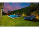 Backyard featuring artificial grass, a modern pool and mature hedges for privacy at 4191 S Emerald Dr, Chandler, AZ 85249