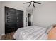 Bedroom with wood-look flooring, ceiling fan, and sliding closet doors at 4191 S Emerald Dr, Chandler, AZ 85249