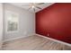 Bright bedroom featuring wood-look tile flooring and a vibrant accent wall at 4191 S Emerald Dr, Chandler, AZ 85249