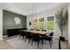 Elegant dining room with stylish lighting, large windows, and views of the greenery outside at 4191 S Emerald Dr, Chandler, AZ 85249