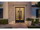 Elegant front entrance with black framed multi-pane glass door and brick surround at 4191 S Emerald Dr, Chandler, AZ 85249