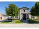 Beautiful home featuring manicured landscaping, mature trees, and a charming brick and stucco facade at 4191 S Emerald Dr, Chandler, AZ 85249