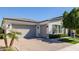 Spacious three-car garage with brick paved driveway complemented by well maintained landscaping at 4191 S Emerald Dr, Chandler, AZ 85249