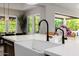 Close-up of a farmhouse sink with a black faucet, complemented by modern fixtures and bright natural light at 4191 S Emerald Dr, Chandler, AZ 85249