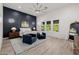 Spacious main bedroom with a large ceiling fan, a striking accent wall, a seating area, and luxury finishes at 4191 S Emerald Dr, Chandler, AZ 85249