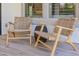 Covered patio sitting area with comfortable lounge chairs and view to the gourmet kitchen through the window at 4191 S Emerald Dr, Chandler, AZ 85249