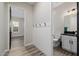 Stylish powder room boasts a dark vanity, beadboard accent, and modern fixtures at 4191 S Emerald Dr, Chandler, AZ 85249