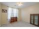 Bedroom with carpeted floors, a ceiling fan, and a large window with decorative curtains at 42297 W Lunar St, Maricopa, AZ 85138