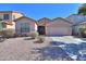 Charming single-story home featuring a well-maintained yard with desert landscaping and a two car garage at 42297 W Lunar St, Maricopa, AZ 85138