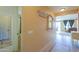 Entryway with tile floors, neutral wall color, decorative mirror, and view into the living room at 42297 W Lunar St, Maricopa, AZ 85138