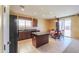 Kitchen with tile floors, a black appliance suite and access to the backyard through sliding glass doors at 42297 W Lunar St, Maricopa, AZ 85138