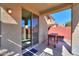 Inviting covered patio area with sliding glass doors for seamless indoor-outdoor living and a small wooden table at 42297 W Lunar St, Maricopa, AZ 85138