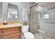 Clean bathroom features a wood vanity and a glass-enclosed shower with neutral tile at 443 W Mulberry Dr, Phoenix, AZ 85013