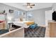 Bright bedroom with a neutral color scheme, ceiling fan, and a black and white patterned rug at 443 W Mulberry Dr, Phoenix, AZ 85013