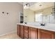 Bathroom featuring double sinks, dark brown cabinets and a view of the soaking tub at 4602 E Firestone Dr, Chandler, AZ 85249