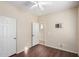 Bedroom featuring wood-look floors, neutral walls, white doors, and wall-mounted TV bracket at 4602 E Firestone Dr, Chandler, AZ 85249