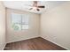 Bright bedroom features wood-look floors, ceiling fan, and a window with modern blinds at 4602 E Firestone Dr, Chandler, AZ 85249