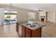 Kitchen island features a stainless steel dishwasher and sink, with a view of the backyard and fireplace at 4602 E Firestone Dr, Chandler, AZ 85249