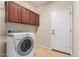 Functional laundry room with tile floors, cabinets, and modern washing machine at 4602 E Firestone Dr, Chandler, AZ 85249