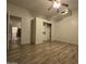 A well-lit bedroom with wood-look floors, a ceiling fan, and a closet with built-in shelving at 46312 N 38Th Ave, New River, AZ 85087