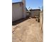 View of backyard featuring dirt, perimeter walls, mature landscaping, and a shed at 4927 W Golden Ln, Glendale, AZ 85302