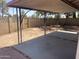 Backyard featuring a covered patio with decorative pillars and a block wall perimeter at 4927 W Golden Ln, Glendale, AZ 85302