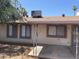 Exterior view of covered patio with pillars and adjacent windows with brown trim at 4927 W Golden Ln, Glendale, AZ 85302