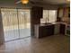 Spacious kitchen with tile flooring, dark wood cabinets, and stainless steel sink at 4927 W Golden Ln, Glendale, AZ 85302