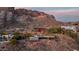 Captivating aerial shot of the house nestled into the mountainside with beautiful views at 4959 E Red Rock Dr, Phoenix, AZ 85018