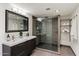 Contemporary bathroom with double sinks, a glass-enclosed shower, and sleek fixtures at 4959 E Red Rock Dr, Phoenix, AZ 85018