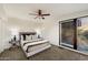 Cozy bedroom featuring a ceiling fan, carpeted floors, and natural light through a window at 4959 E Red Rock Dr, Phoenix, AZ 85018