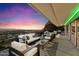 Spacious covered deck with ample seating, offering panoramic city and mountain views at sunset at 4959 E Red Rock Dr, Phoenix, AZ 85018
