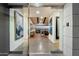 Modern home entryway featuring glass doors, concrete floors, and a glimpse of the living area at 4959 E Red Rock Dr, Phoenix, AZ 85018