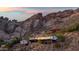 Stunning exterior shot of a modern home built into the side of a mountain at 4959 E Red Rock Dr, Phoenix, AZ 85018