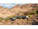 Exterior view of a house built on a rocky hillside with mountain views at 4959 E Red Rock Dr, Phoenix, AZ 85018