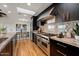 Gourmet kitchen features stainless steel appliances, granite countertops, and wood flooring at 4959 E Red Rock Dr, Phoenix, AZ 85018