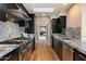 Modern kitchen featuring stainless steel appliances, granite countertops, and dark wood cabinets at 4959 E Red Rock Dr, Phoenix, AZ 85018