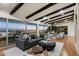 Living room with large windows offering city views, a gray sofa, and modern decor at 4959 E Red Rock Dr, Phoenix, AZ 85018