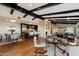Open living space with hardwood floors, beamed ceilings, kitchen, and modern furnishings at 4959 E Red Rock Dr, Phoenix, AZ 85018