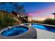 Backyard pool and hot tub with stunning views of the valley at twilight at 4959 E Red Rock Dr, Phoenix, AZ 85018